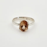 Anillo de Topacio Imperial Naranja Rojizo en Plata 950 con engaste de grifas y corte oval. - Anillos
