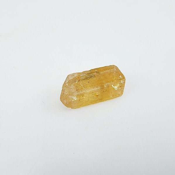Topacio Imperial en bruto procedente de Brasil con cristalización rectangular y suave tono marrón caramelo - Minerales de colección